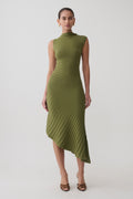 Woman wearing a green pleated knit dress.