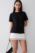 Woman wearing a black cotton oversized t-shirt.