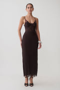 Woman wearing a dark brown lace and mesh midi dress.