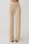 Woman wearing beige knit pants.