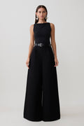 Woman wearing a black oversized jean with front pleat.